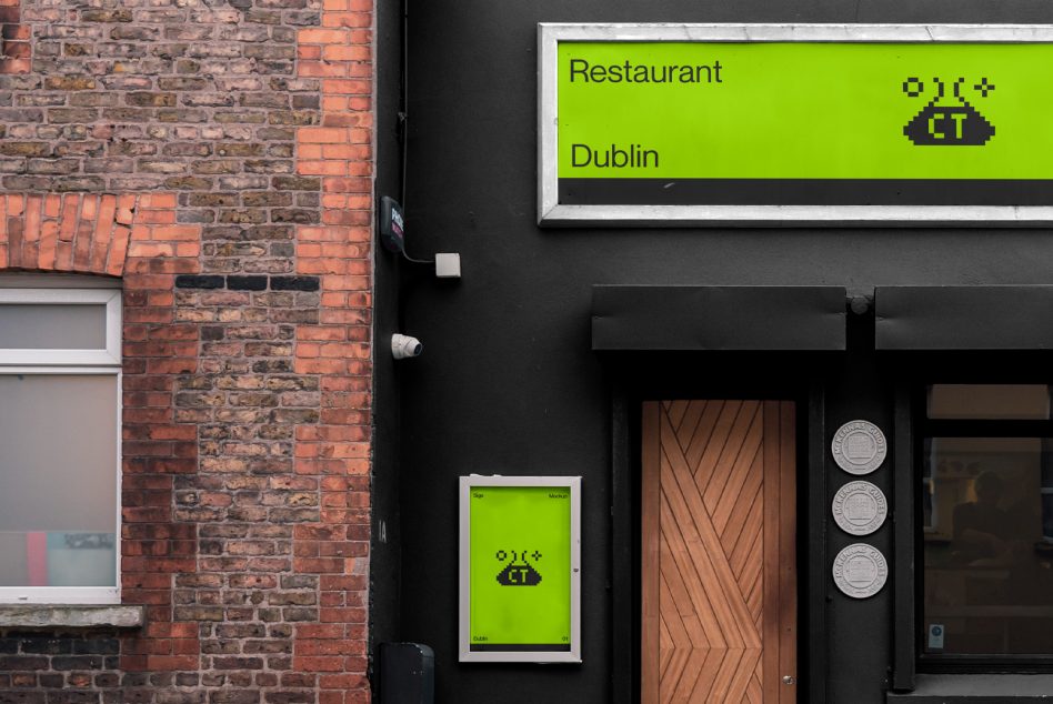 Urban restaurant exterior with bright green signage, brick wall, and stylish wooden door perfect for mockup graphics or template design.